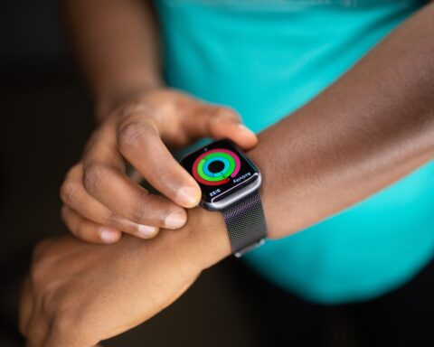 person wearing silver aluminum case apple watch with white sport band